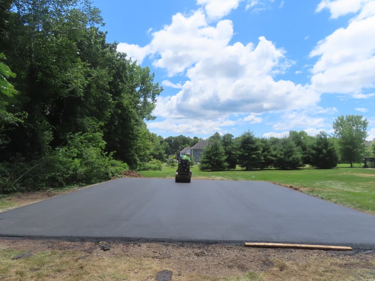 Asphalt Pad Paving project in North Haven, CT — finished asphalt pad blue sky