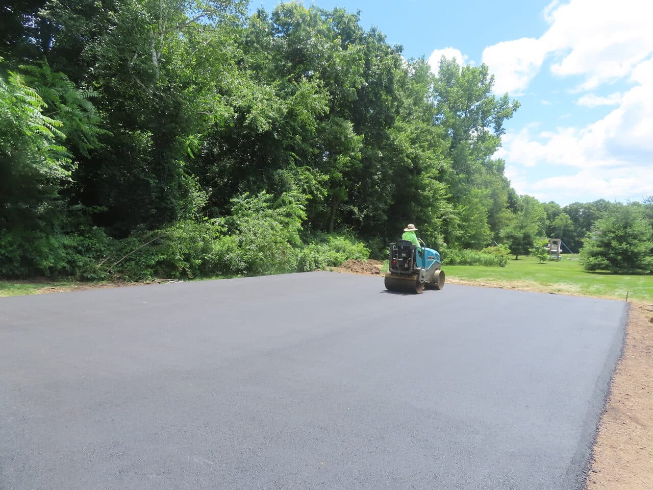 Asphalt Pad Paving project in North Haven, CT — finished asphalt pad with roller