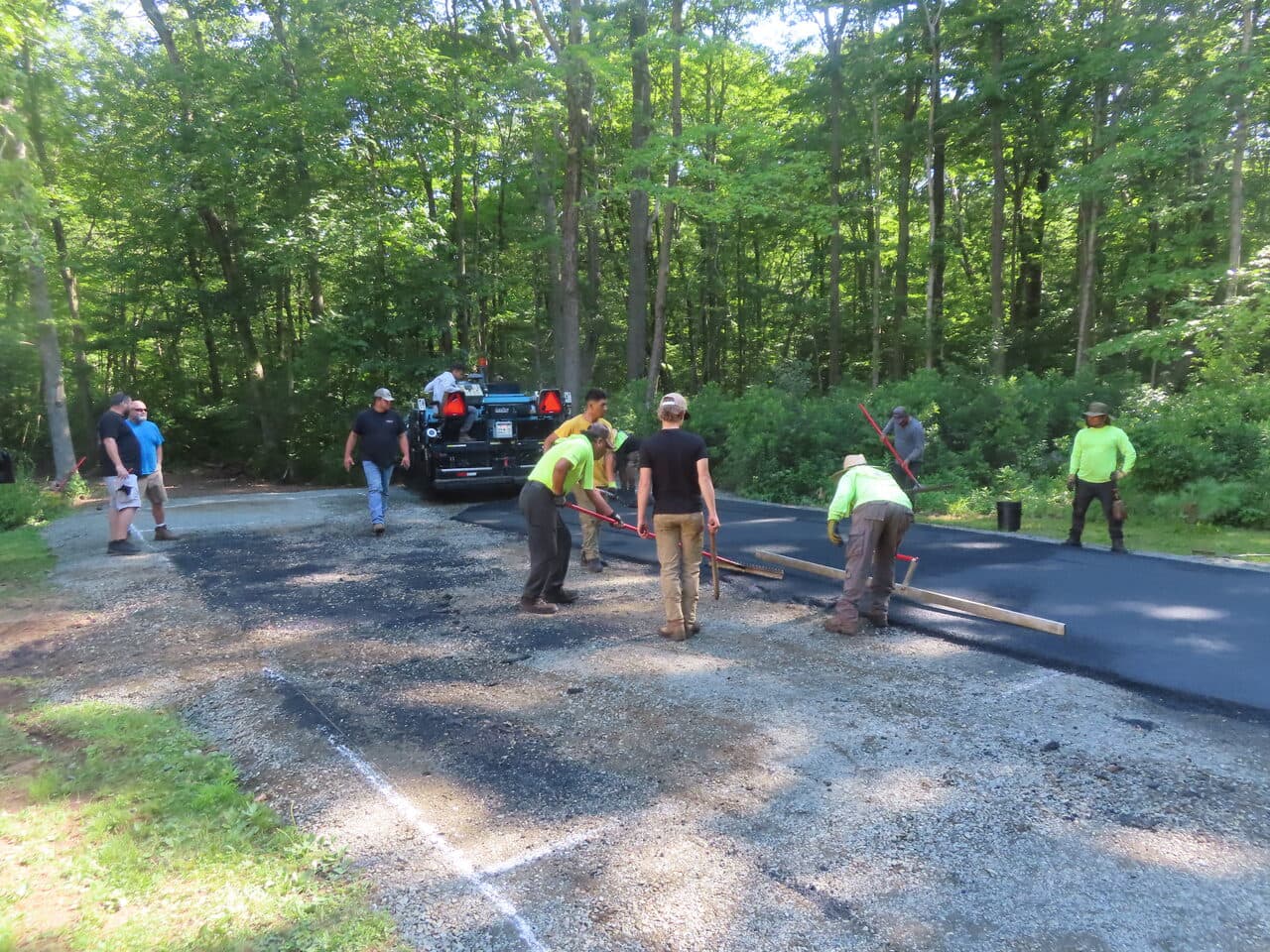Multi-Stop Residential Driveway Paving project in Durham & Wallingford, CT — crew paving residential driveway entrance