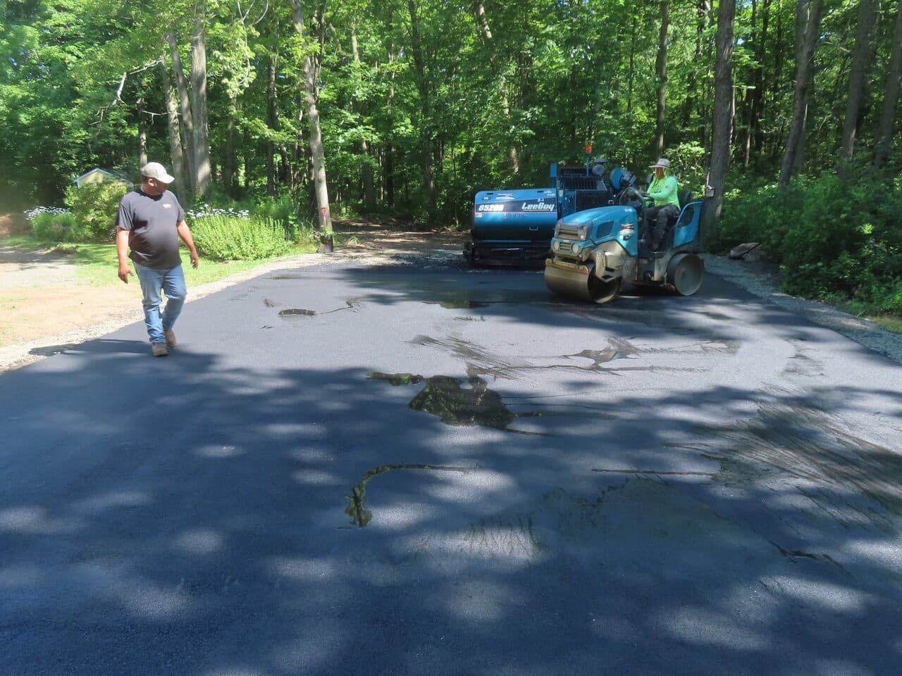 Multi-Stop Residential Driveway Paving project in Durham & Wallingford, CT — roller over worn cracked driveway
