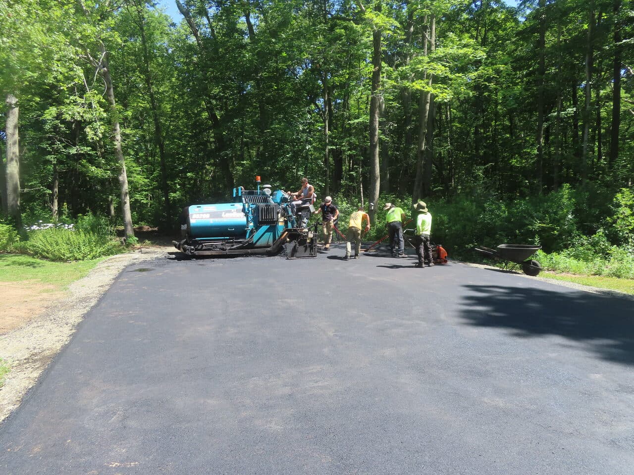 Multi-Stop Residential Driveway Paving project in Durham & Wallingford, CT — paver finishing wide driveway section