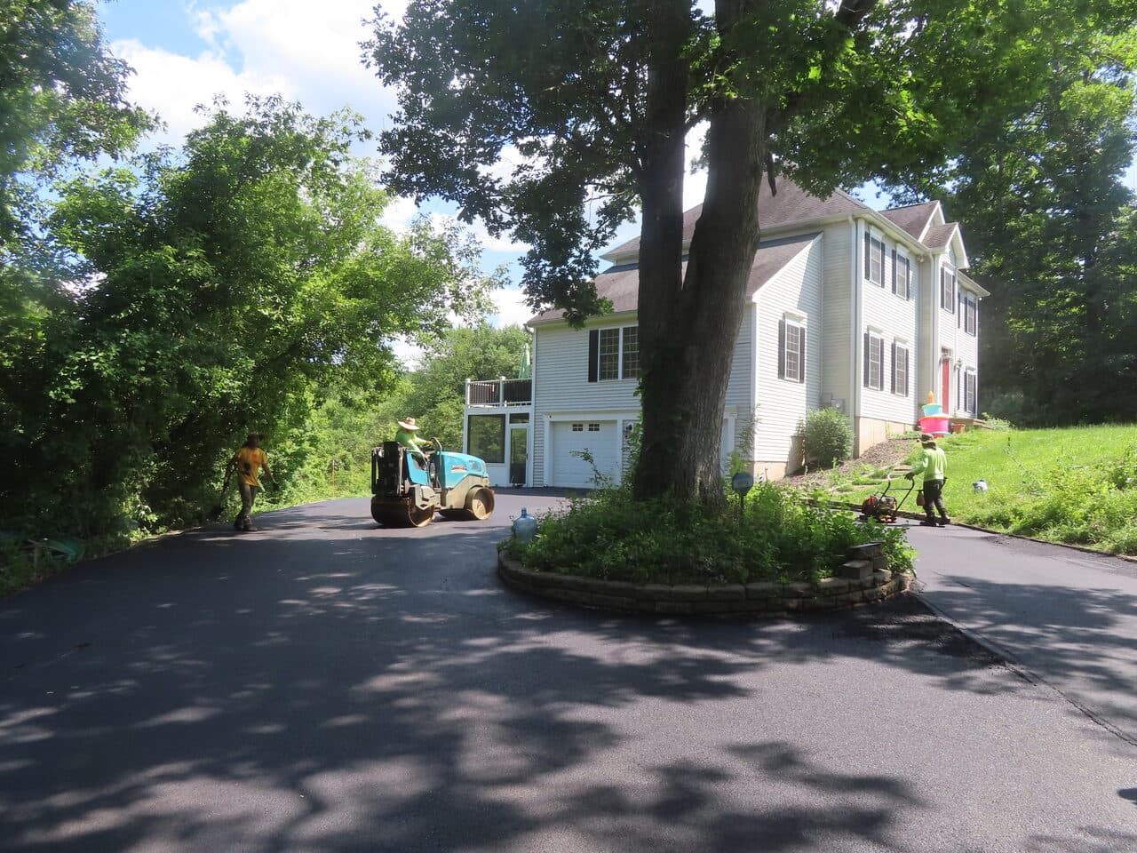 Multi-Stop Residential Driveway Paving project in Durham & Wallingford, CT — finished driveway curving to house