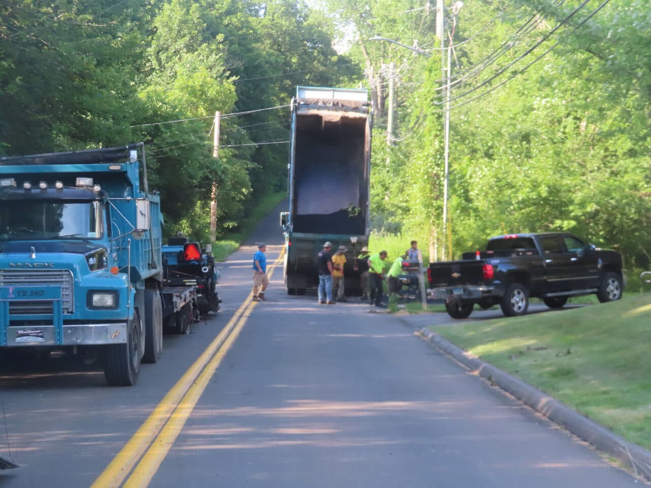 Multi-Stop Residential Driveway Paving project in Durham & Wallingford, CT — finished asphalt road through greenery