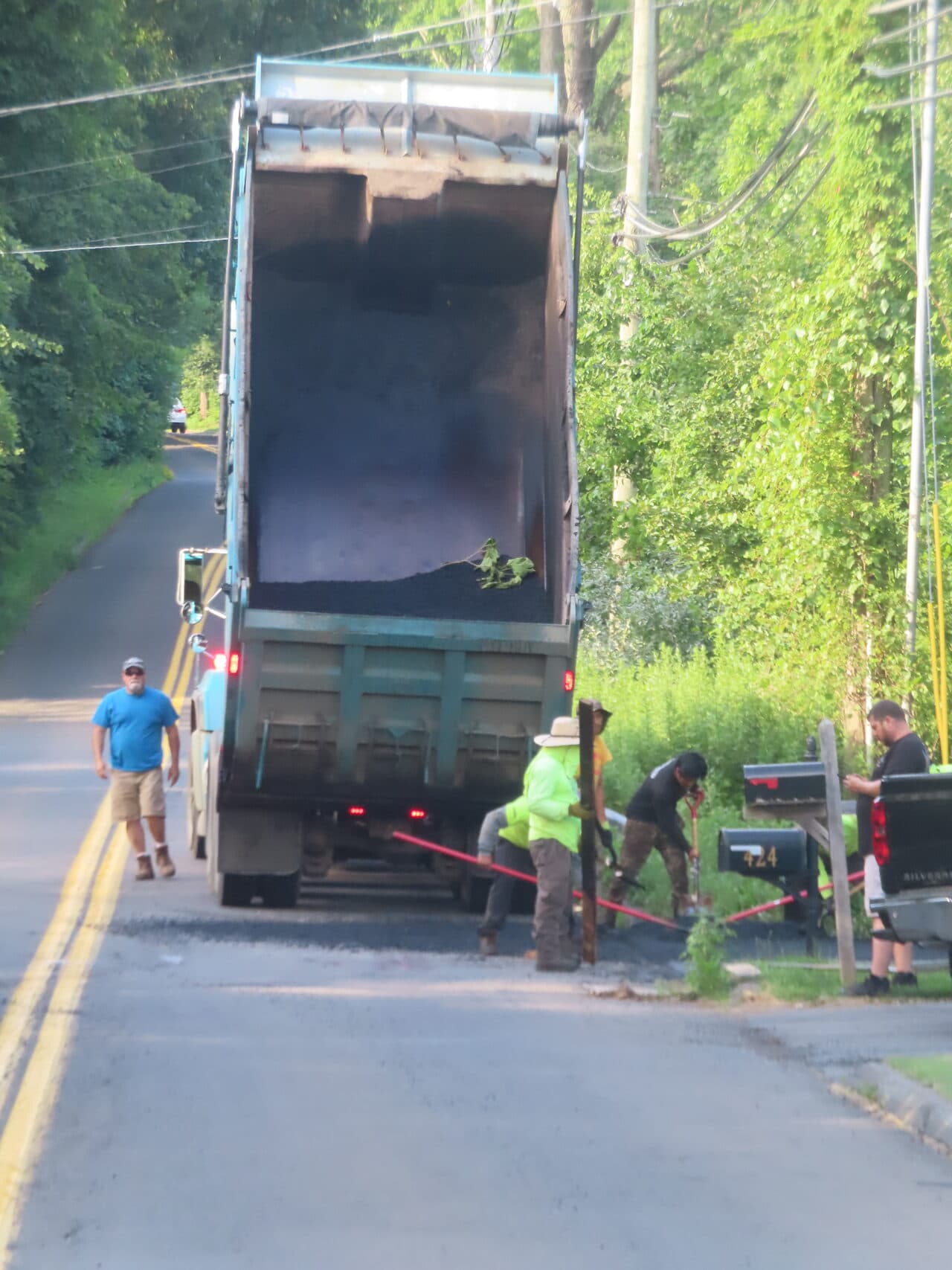 Multi-Stop Residential Driveway Paving project in Durham & Wallingford, CT — dump truck unloading asphalt at mailbox
