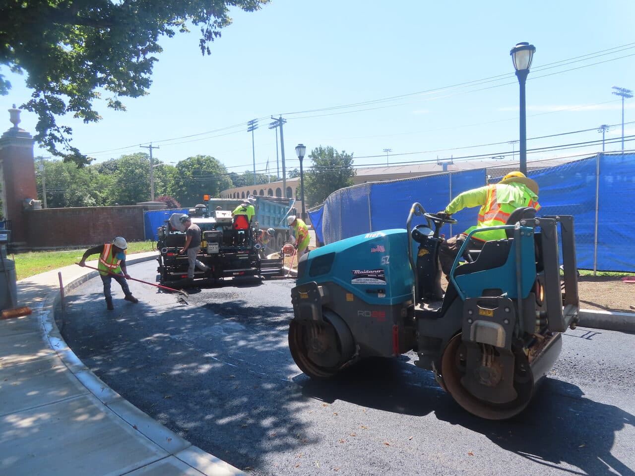 Institutional Asphalt Paving project in New Haven, CT — paver and roller compacting curve