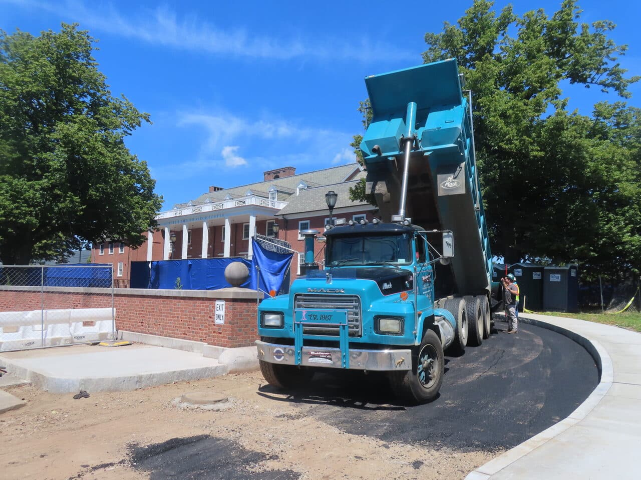 Institutional Asphalt Paving project in New Haven, CT — blue dump truck unloading asphalt