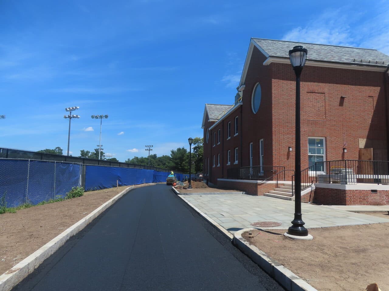 Institutional Asphalt Paving project in New Haven, CT — finished road beside brick building