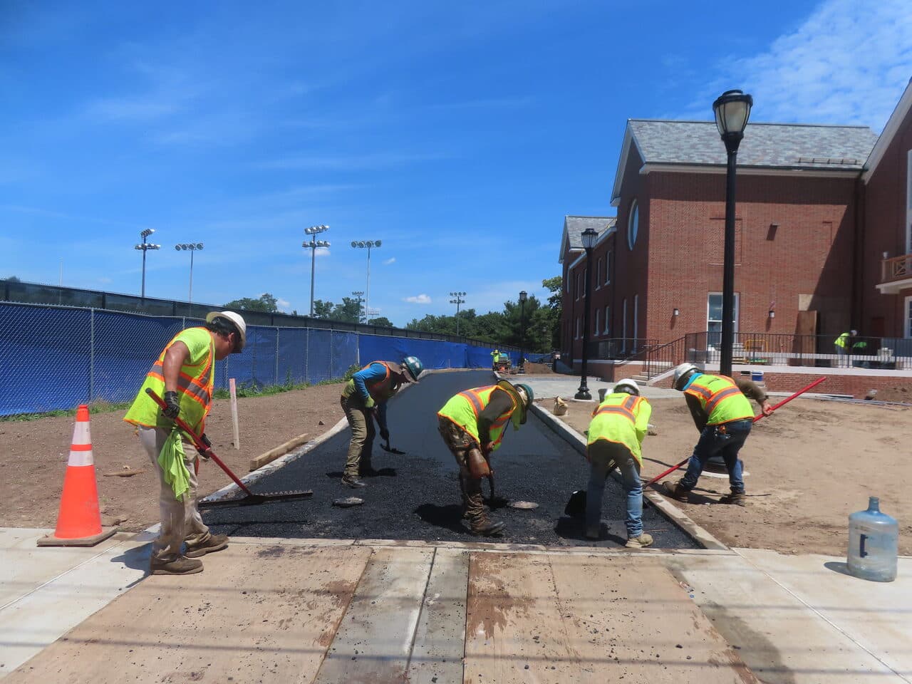 Institutional Asphalt Paving project in New Haven, CT — crew raking and grading new path