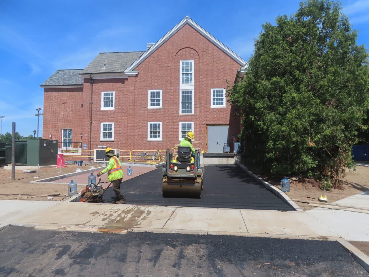 Institutional Asphalt Paving project in New Haven, CT — roller compacting ramp asphalt