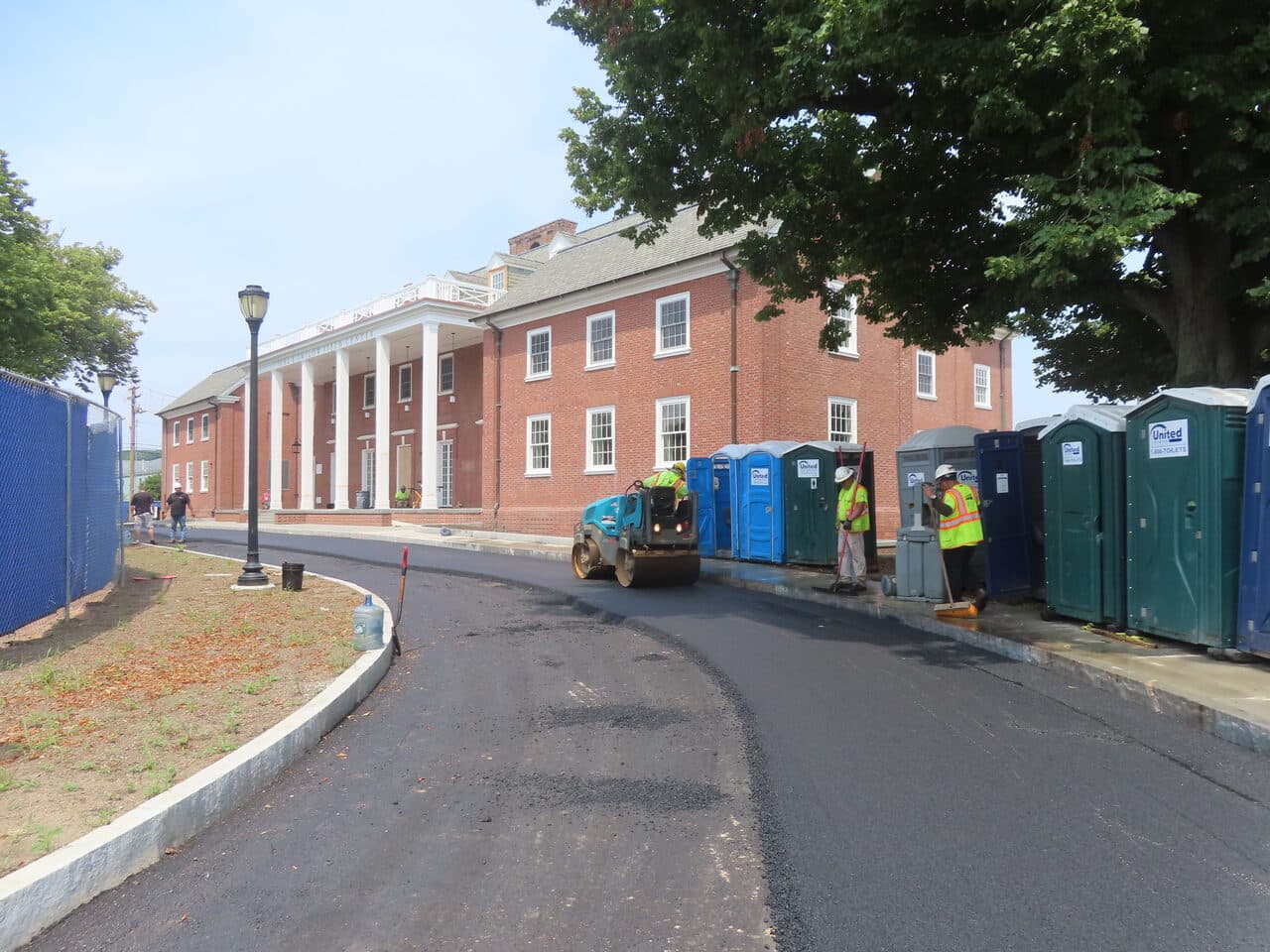 Institutional Asphalt Paving project in New Haven, CT — fresh asphalt roadway by brick building