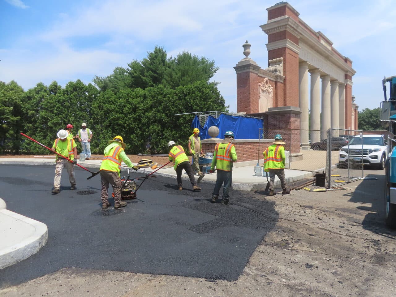 Institutional Asphalt Paving project in New Haven, CT — crew hand-raking asphalt at plaza