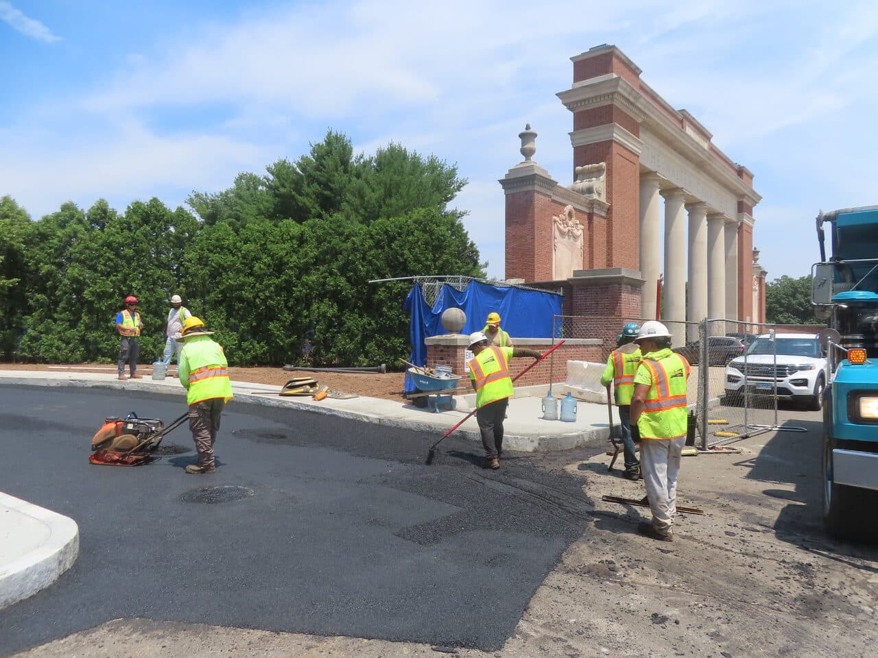 Institutional Asphalt Paving project in New Haven, CT — crew compacting asphalt near monument