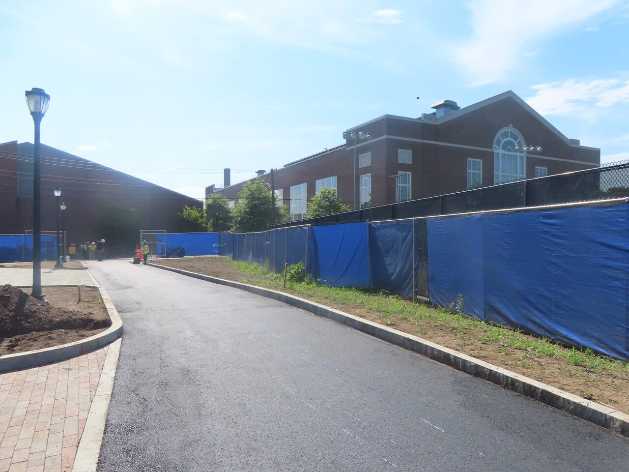 After — Institutional Asphalt Paving in New Haven, CT (graded base before paving by fence)