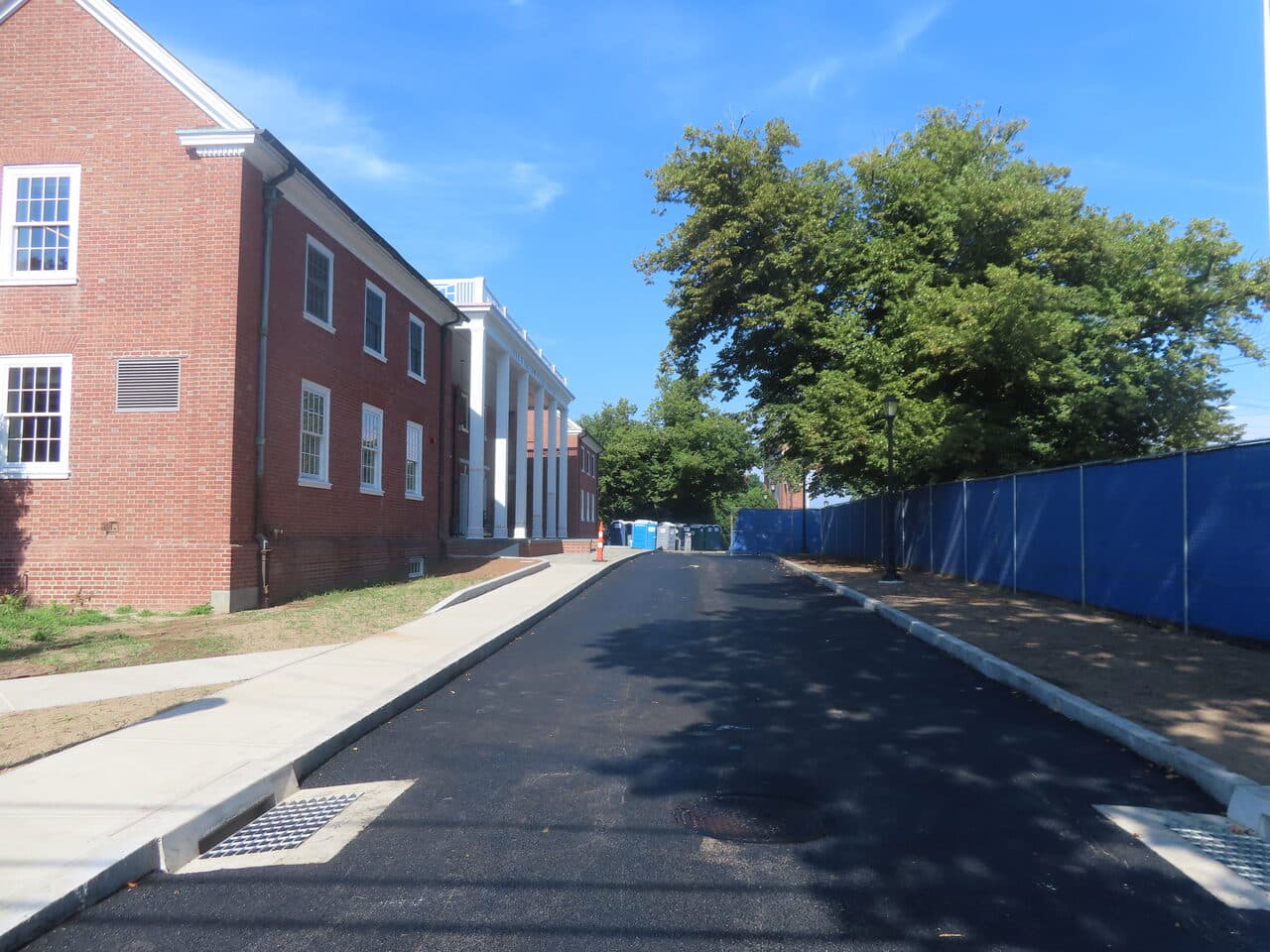 Institutional Asphalt Paving project in New Haven, CT — finished asphalt drive with drain grate
