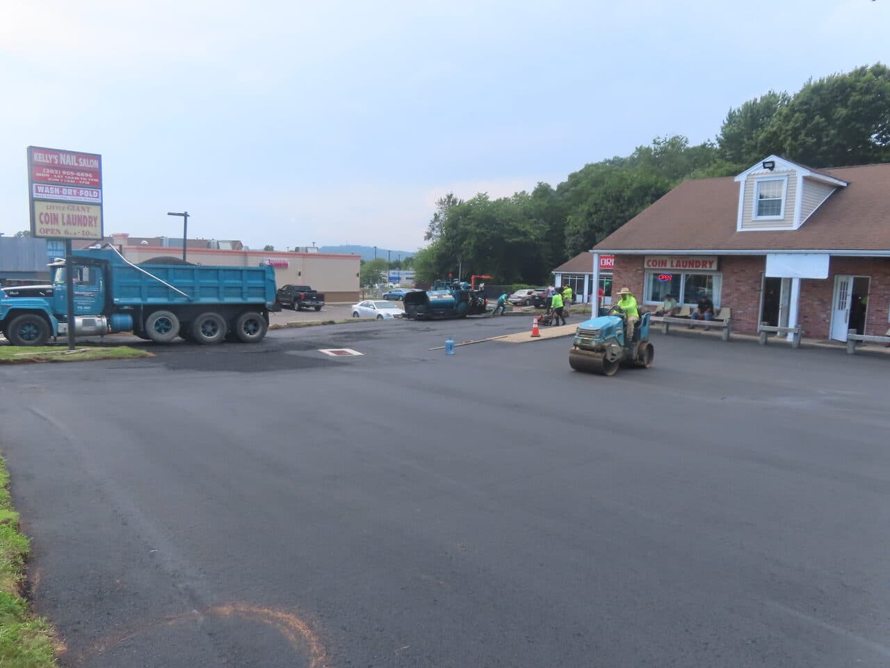 Commercial Plaza Paving project in New Haven, CT — roller compacting new commercial lot