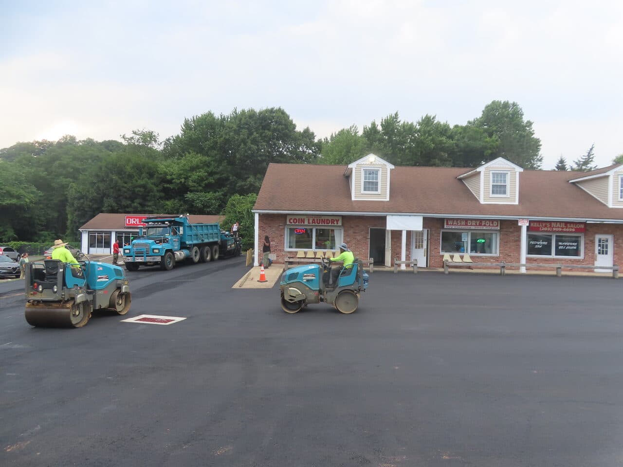 Commercial Plaza Paving project in New Haven, CT — two rollers compacting fresh lot