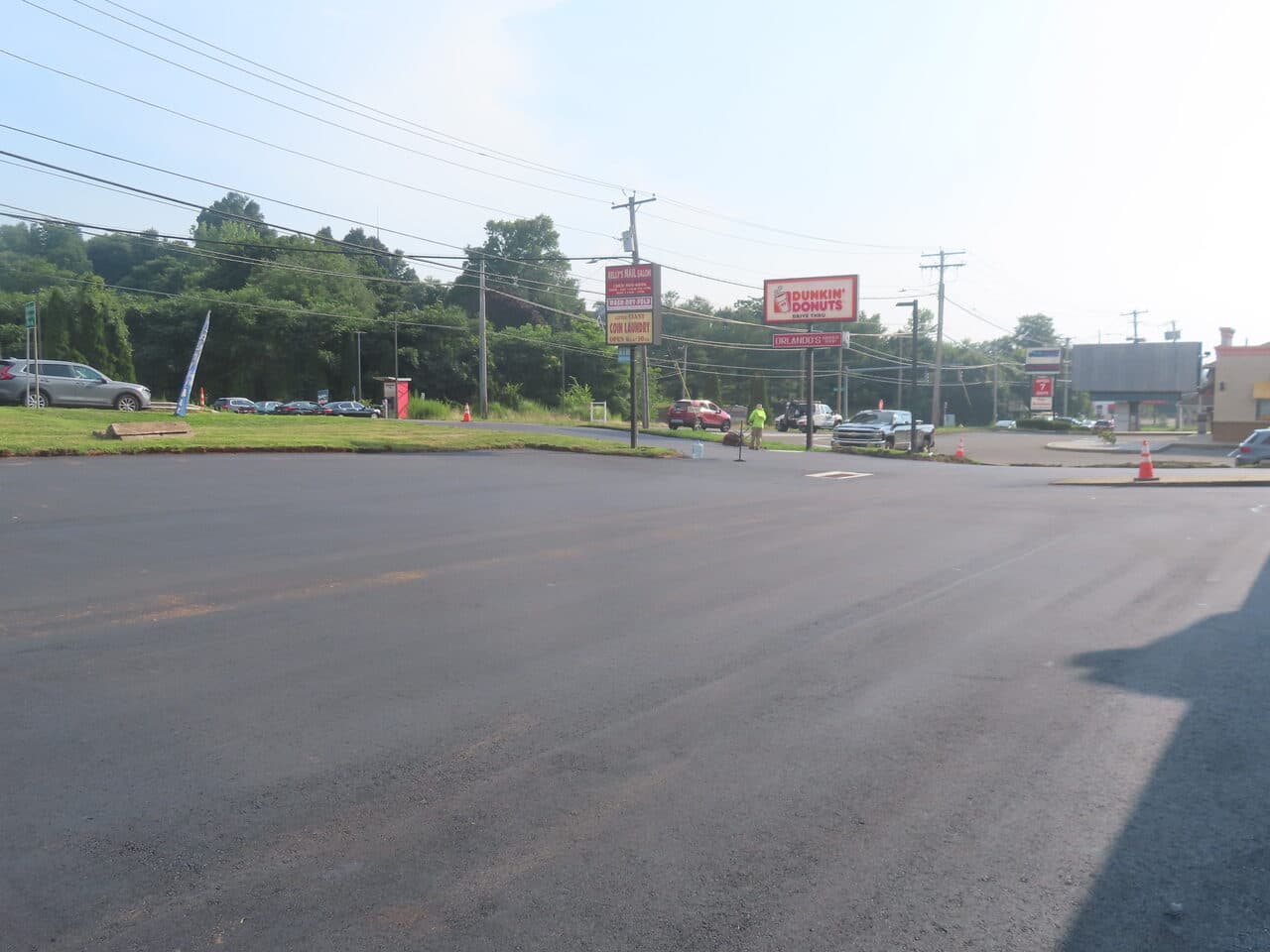 Commercial Plaza Paving project in New Haven, CT — paving with dump truck and rollers