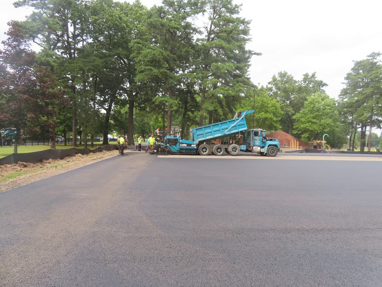Commercial Parking Lot Paving project in Springfield, MA — paver and dump truck on new lot