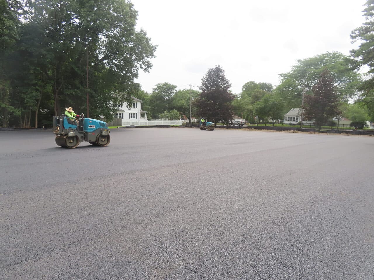 Commercial Parking Lot Paving project in Springfield, MA — rollers compacting new asphalt lot