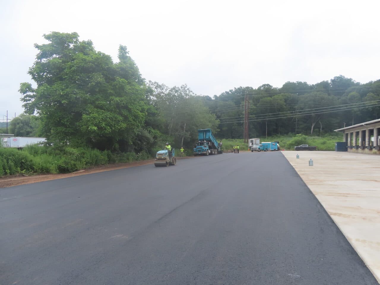 Commercial Parking Lot Paving project in Northford, CT — fresh asphalt lot beside loading dock