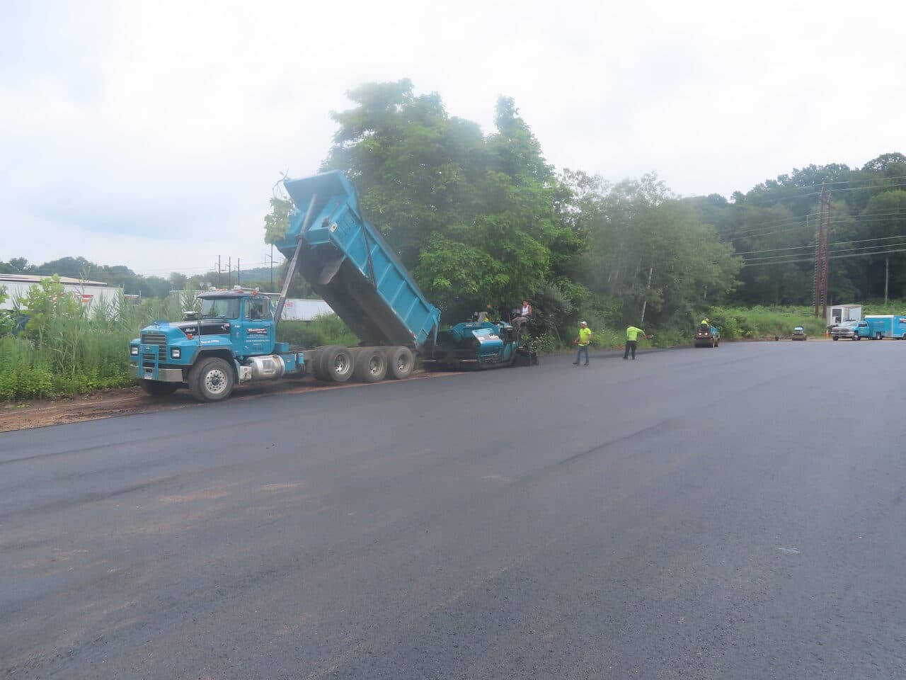 Commercial Parking Lot Paving project in Northford, CT — dump truck feeding paver