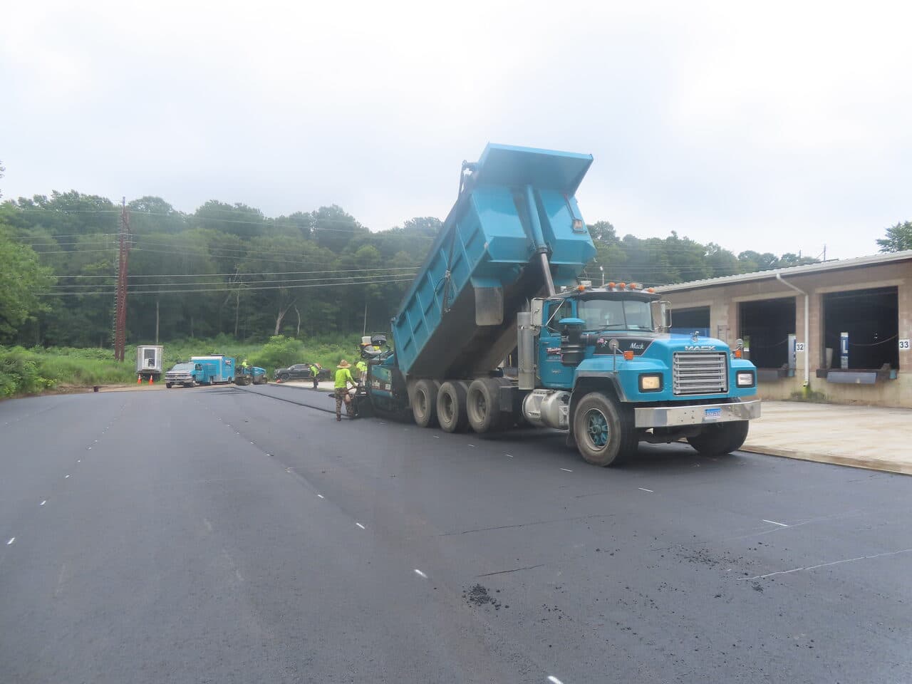 Commercial Parking Lot Paving project in Northford, CT — Mack dump truck and paver at dock