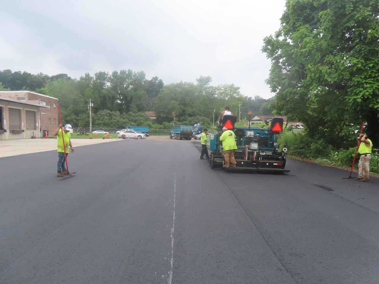Commercial Parking Lot Paving project in Northford, CT — paver laying mat along building