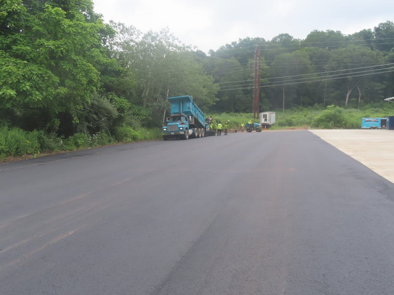 Commercial Parking Lot Paving project in Northford, CT — wide finished asphalt with dump truck