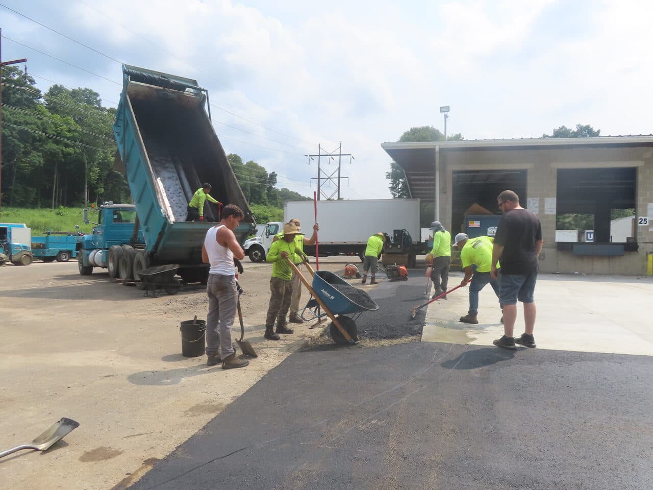 Commercial Parking Lot Paving project in Northford, CT — crew patching apron with wheelbarrow
