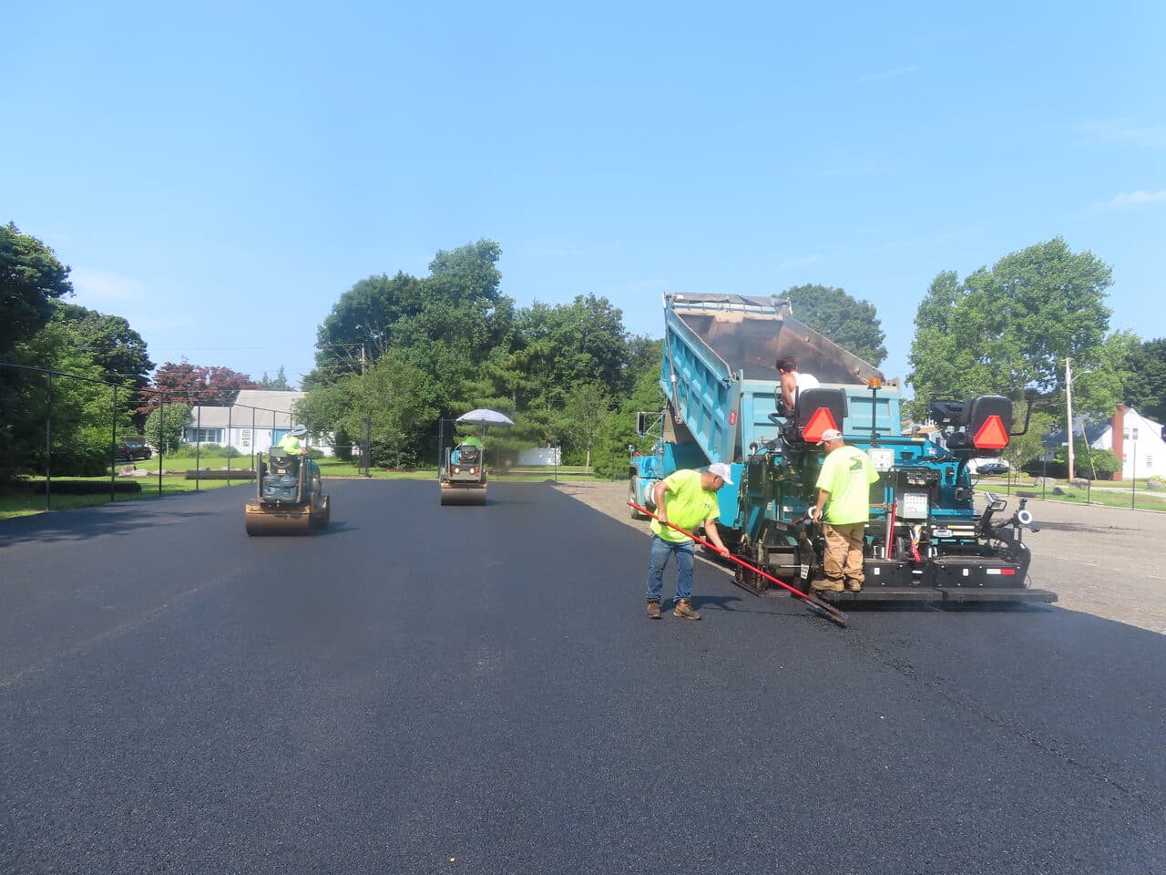 Commercial Parking Lot Paving project in Barrington, RI — paving crew with paver and rollers