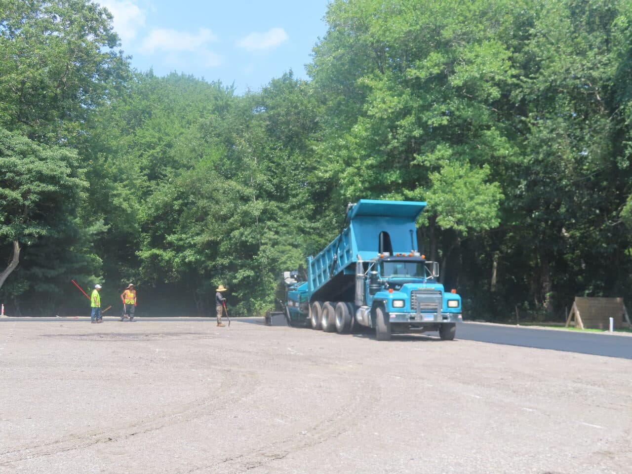 Commercial Parking Lot Paving project in Barrington, RI — dump truck spreading asphalt