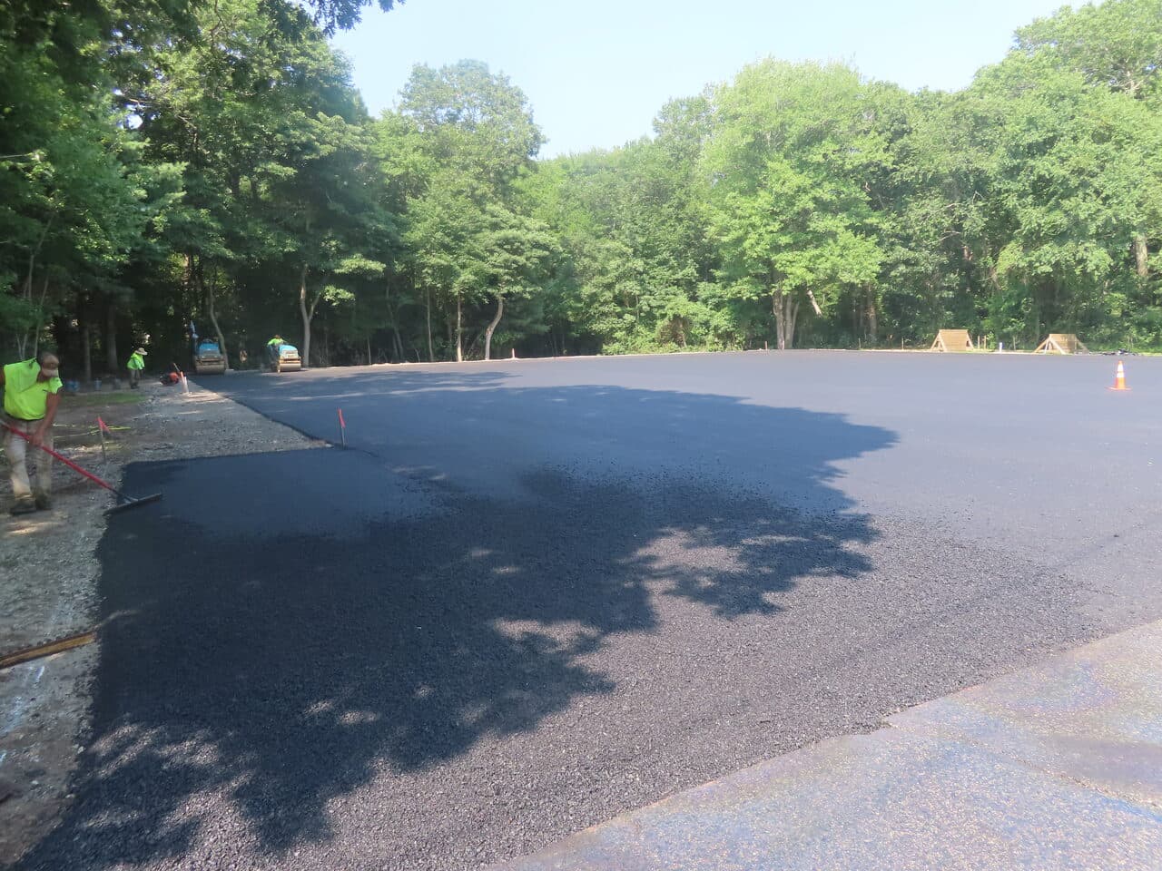 Commercial Parking Lot Paving project in Barrington, RI — fresh asphalt edge being placed