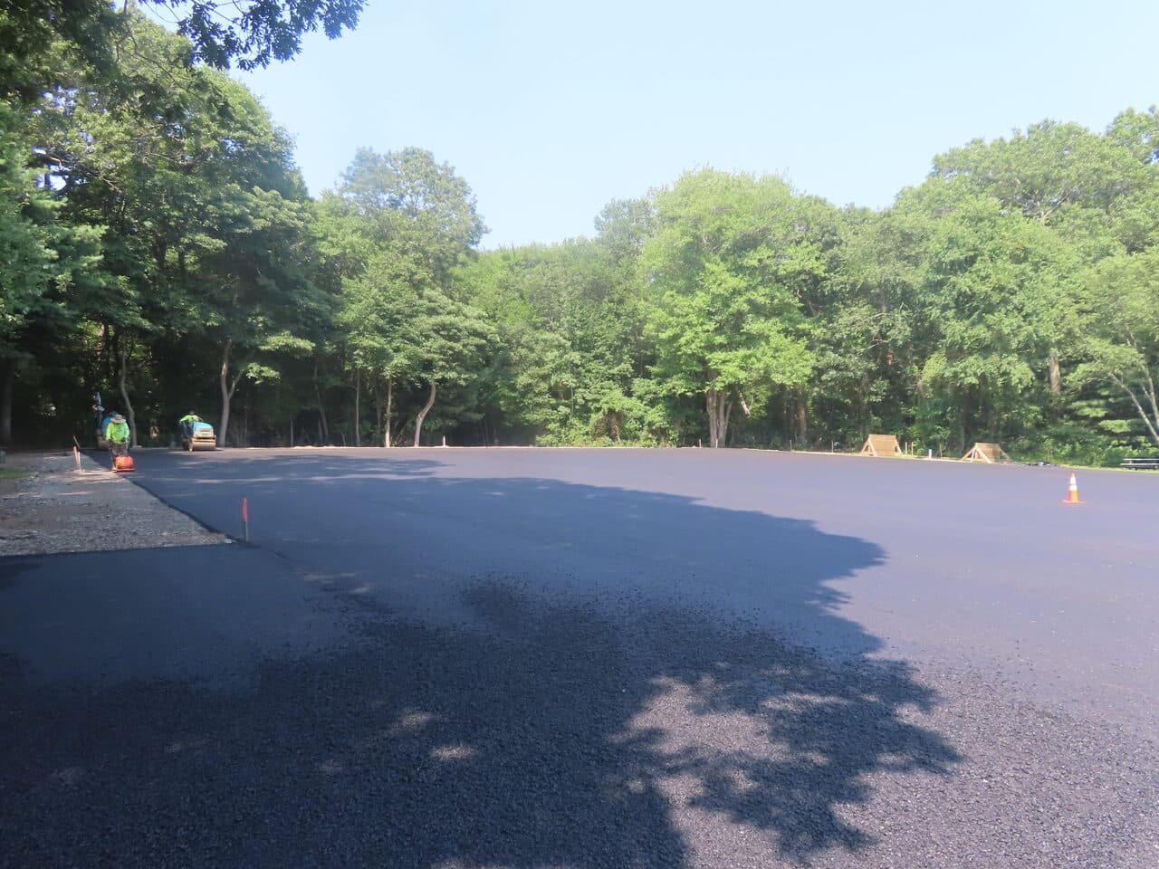 Commercial Parking Lot Paving project in Barrington, RI — finished asphalt lot in trees