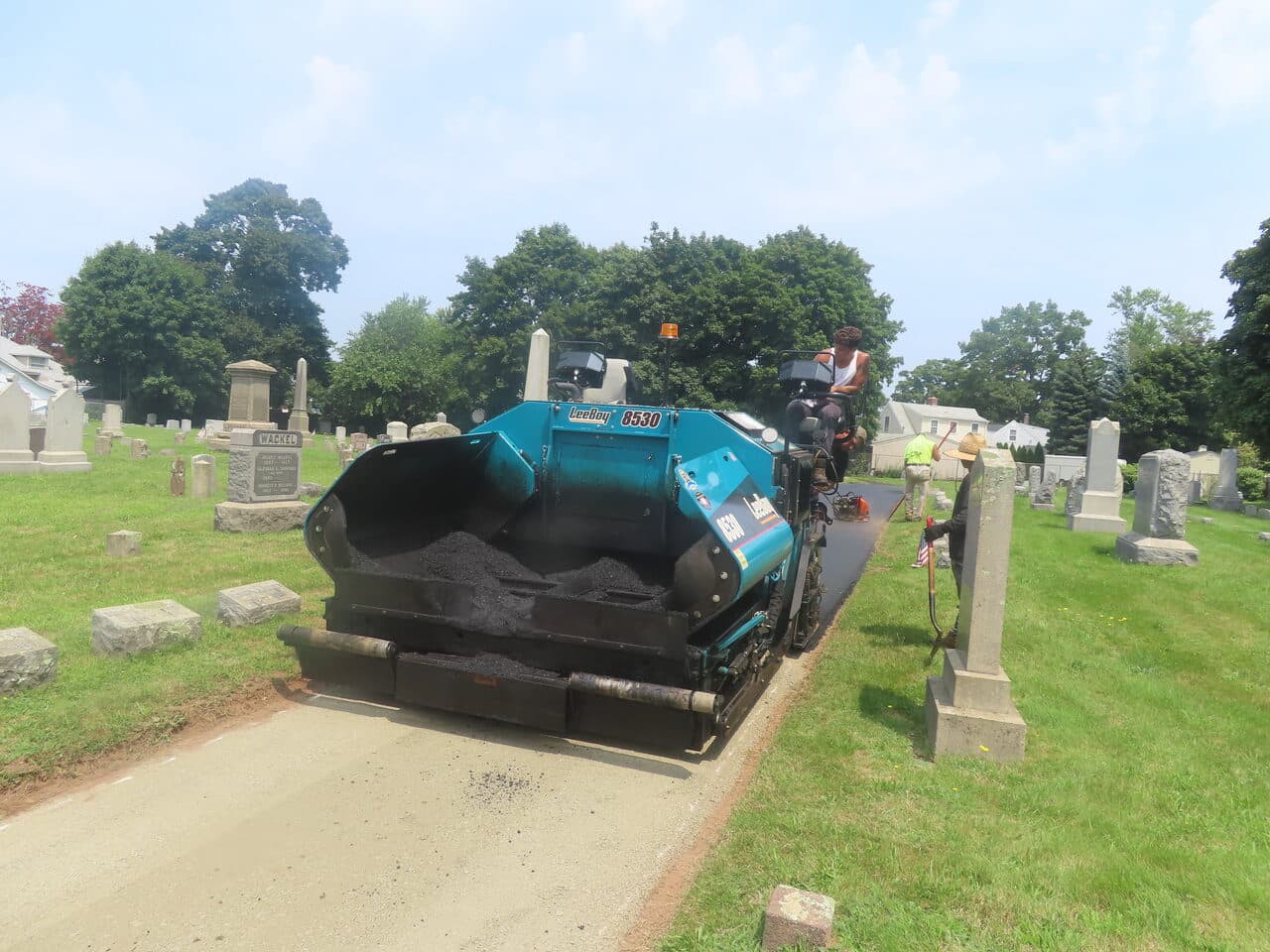 Cemetery Roadway & Walkway Paving project in East Haven, CT — paver laying asphalt on lane