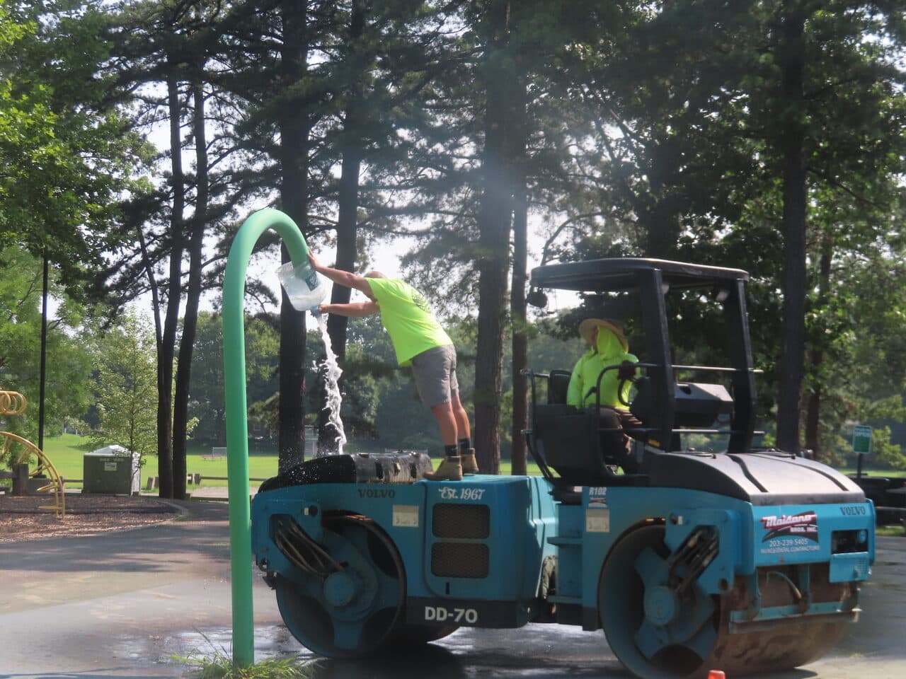 Commercial Parking Lot Paving project in Springfield, MA — worker filling roller water tank