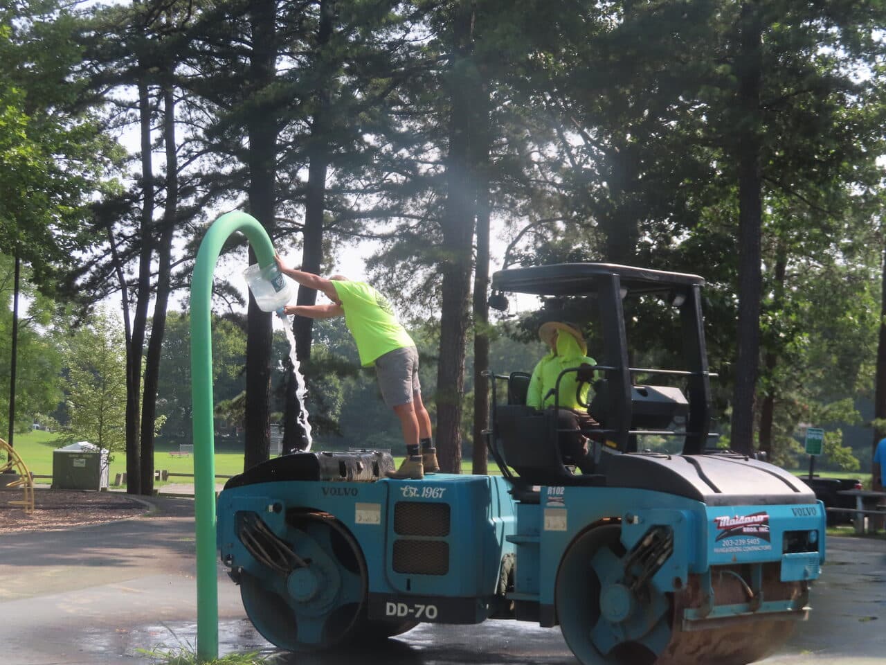 Commercial Parking Lot Paving project in Springfield, MA — worker filling roller water tank