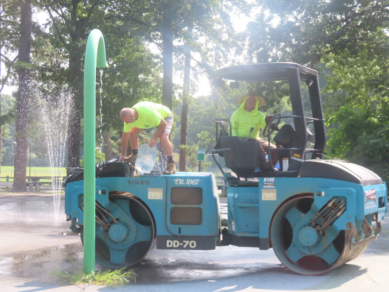 Commercial Parking Lot Paving project in Springfield, MA — crew refilling roller at park