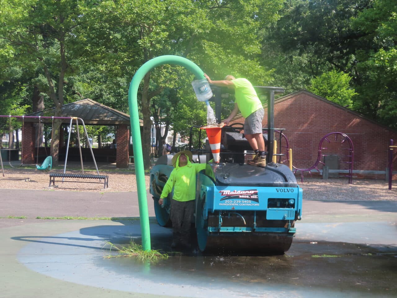 Commercial Parking Lot Paving project in Springfield, MA — roller with branded truck logo