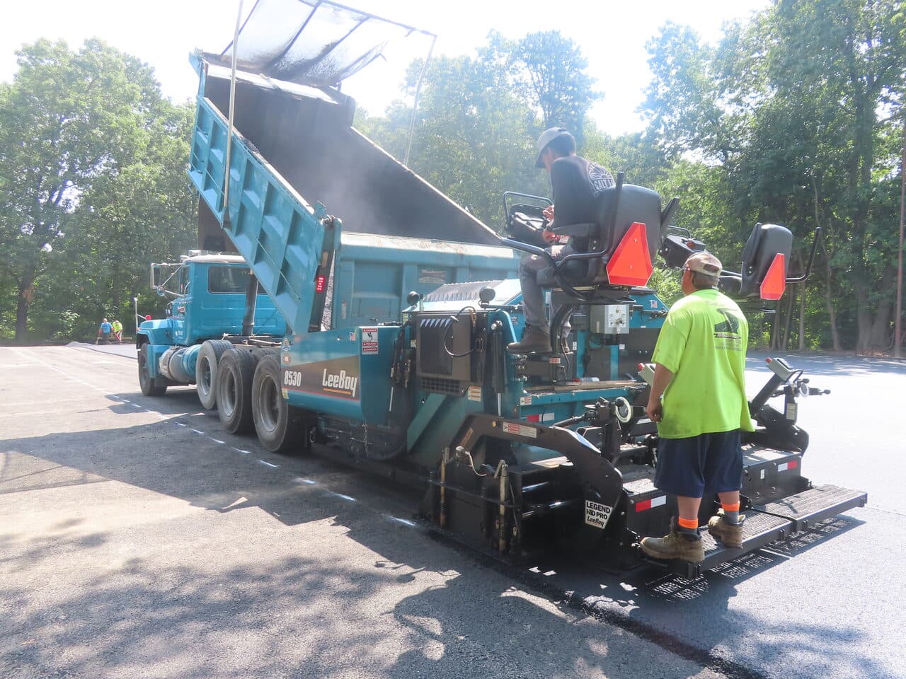 Commercial Parking Lot Paving project in Springfield, MA — paver receiving asphalt from truck