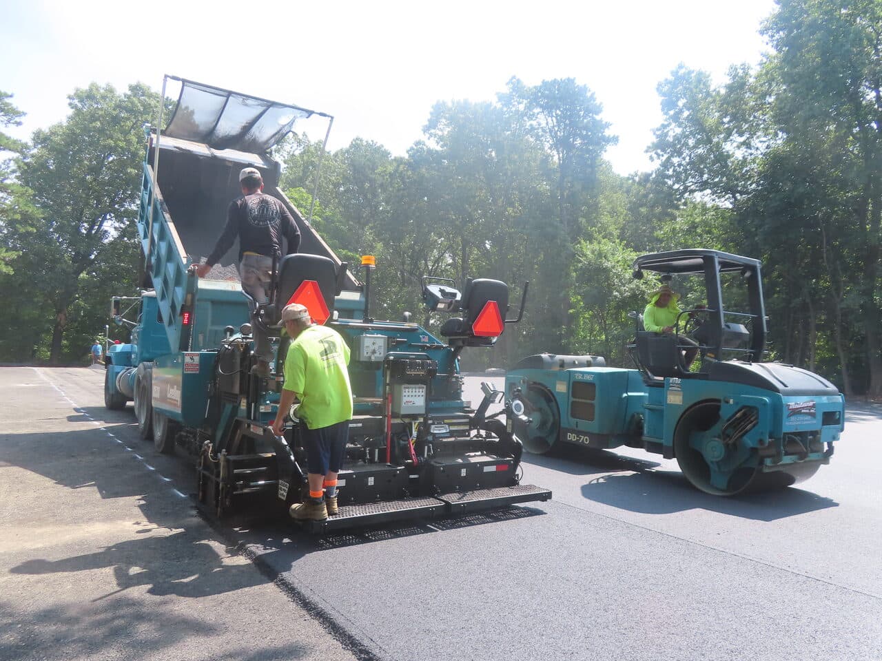 Commercial Parking Lot Paving project in Springfield, MA — paver and roller working lot