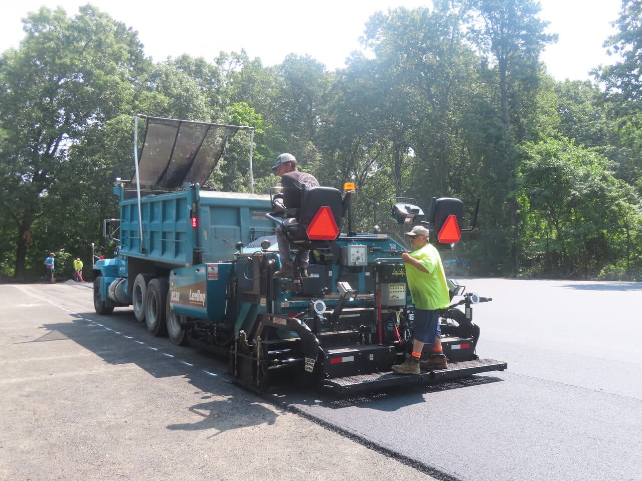 Commercial Parking Lot Paving project in Springfield, MA — paver and dump truck on lot