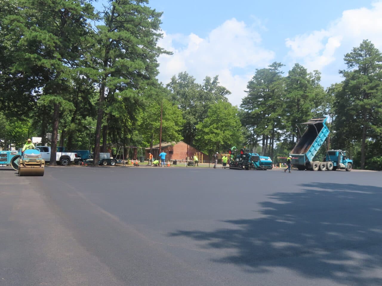 Commercial Parking Lot Paving project in Springfield, MA — wide fresh paved lot with crew