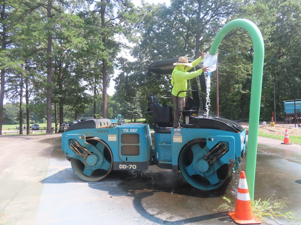 Commercial Parking Lot Paving project in Springfield, MA — worker filling roller water tank