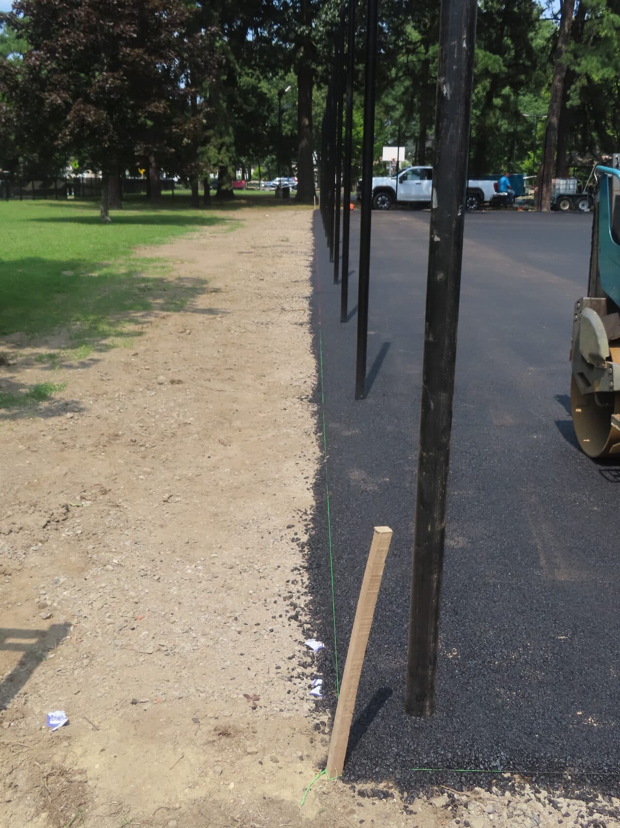 Commercial Parking Lot Paving project in Springfield, MA — fresh asphalt edge along fence line