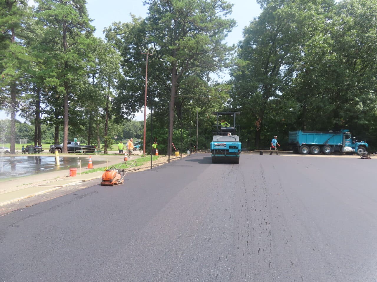 Commercial Parking Lot Paving project in Springfield, MA — roller compacting fresh asphalt lot