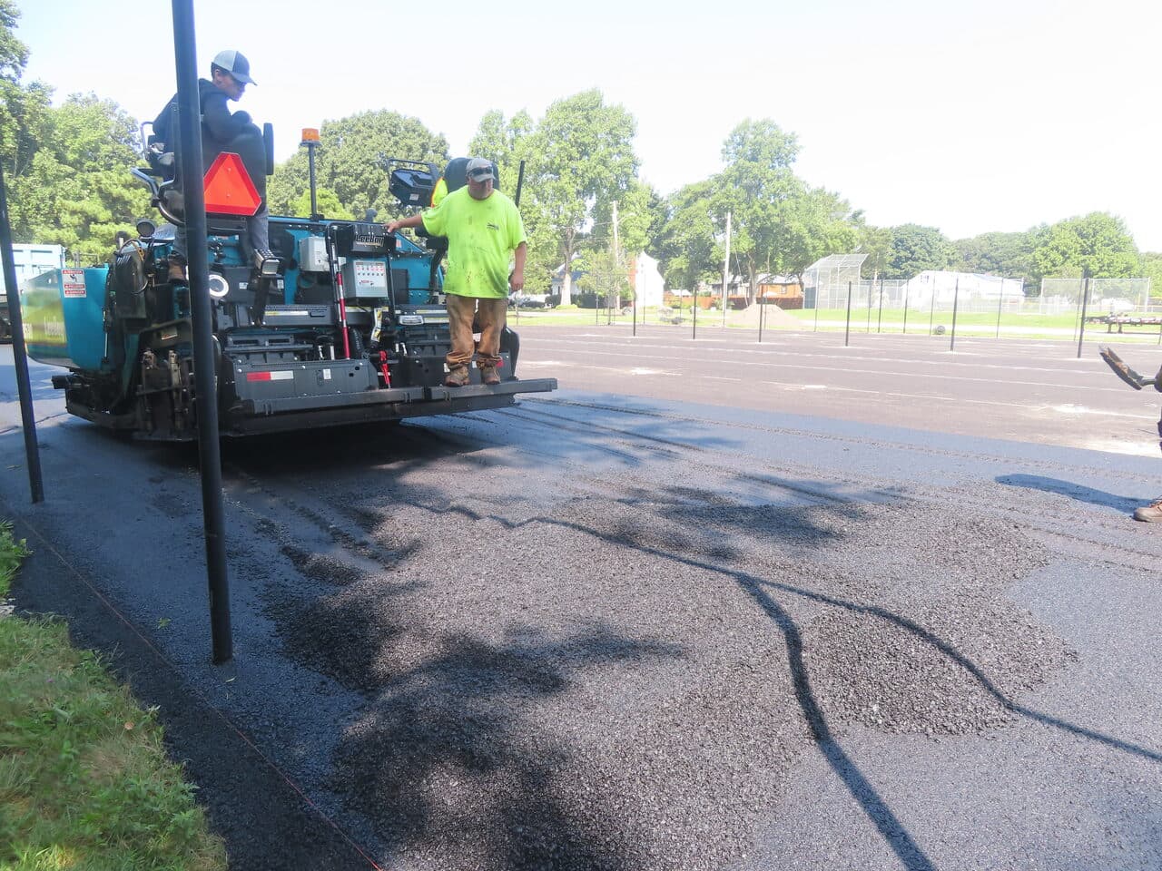 Commercial Parking Lot Paving project in Barrington, RI — paver laying asphalt