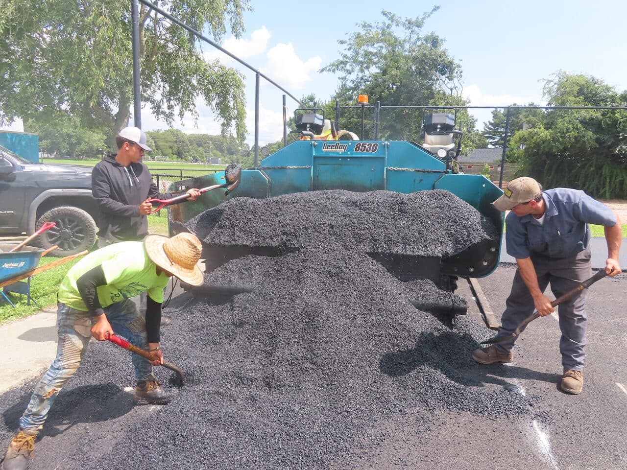Commercial Parking Lot Paving project in Barrington, RI — workers shoveling asphalt pile