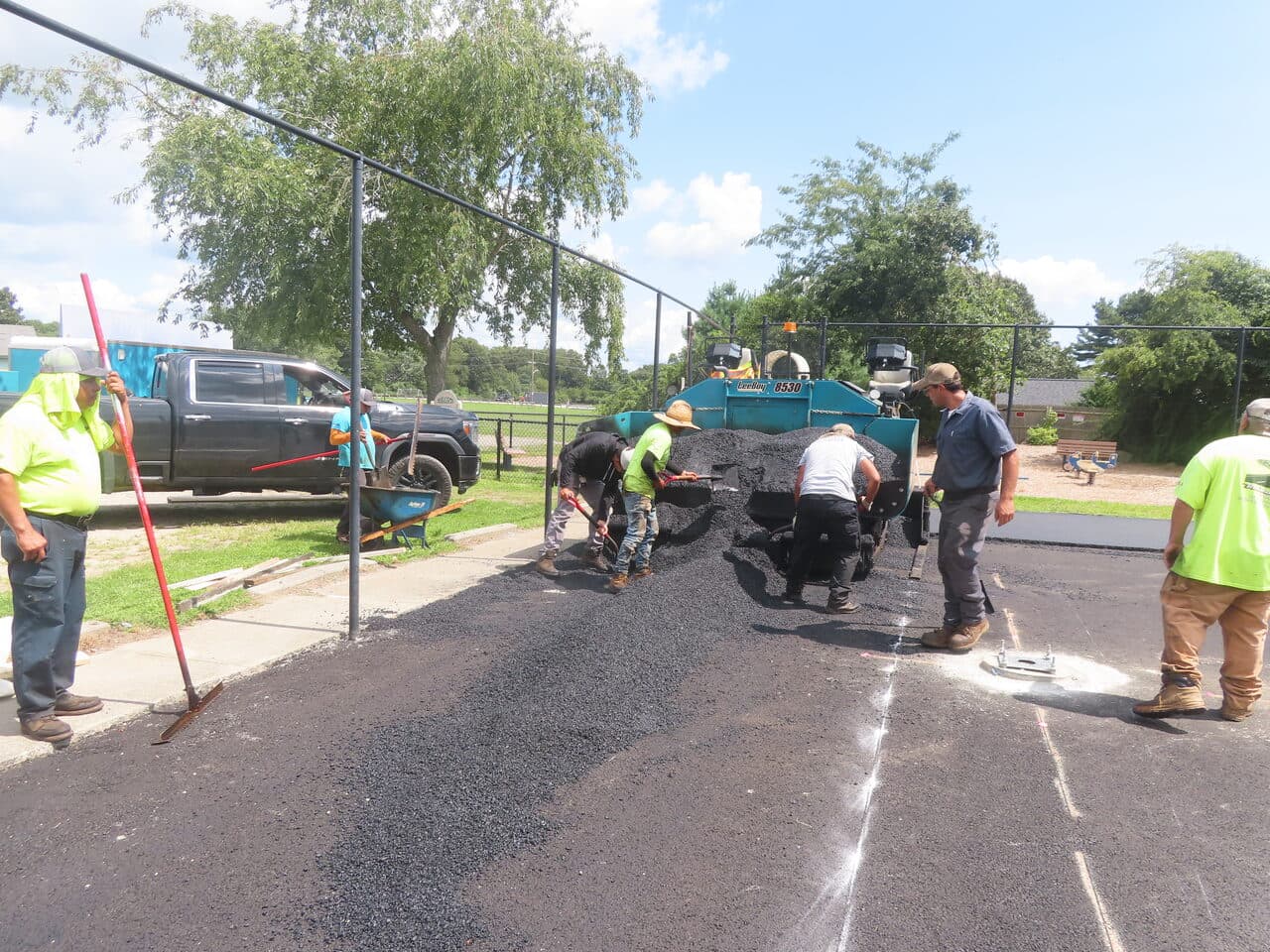 Commercial Parking Lot Paving project in Barrington, RI — crew hand work near catch basin