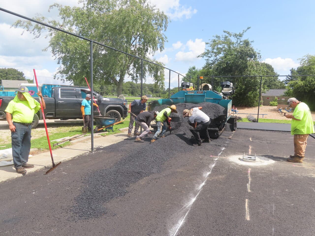 Commercial Parking Lot Paving project in Barrington, RI — crew spreading asphalt by hand
