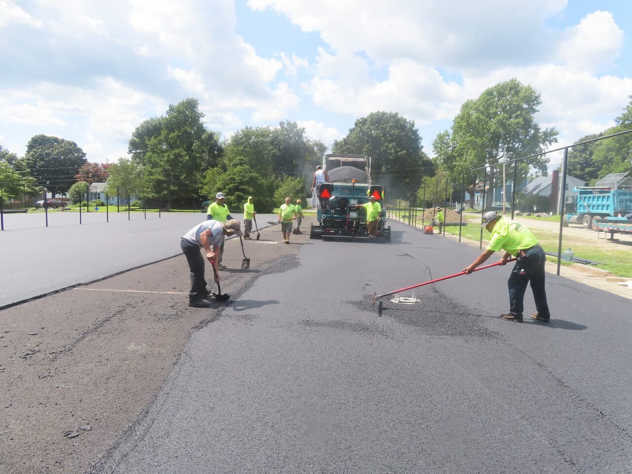 Commercial Parking Lot Paving project in Barrington, RI — crew raking behind paver